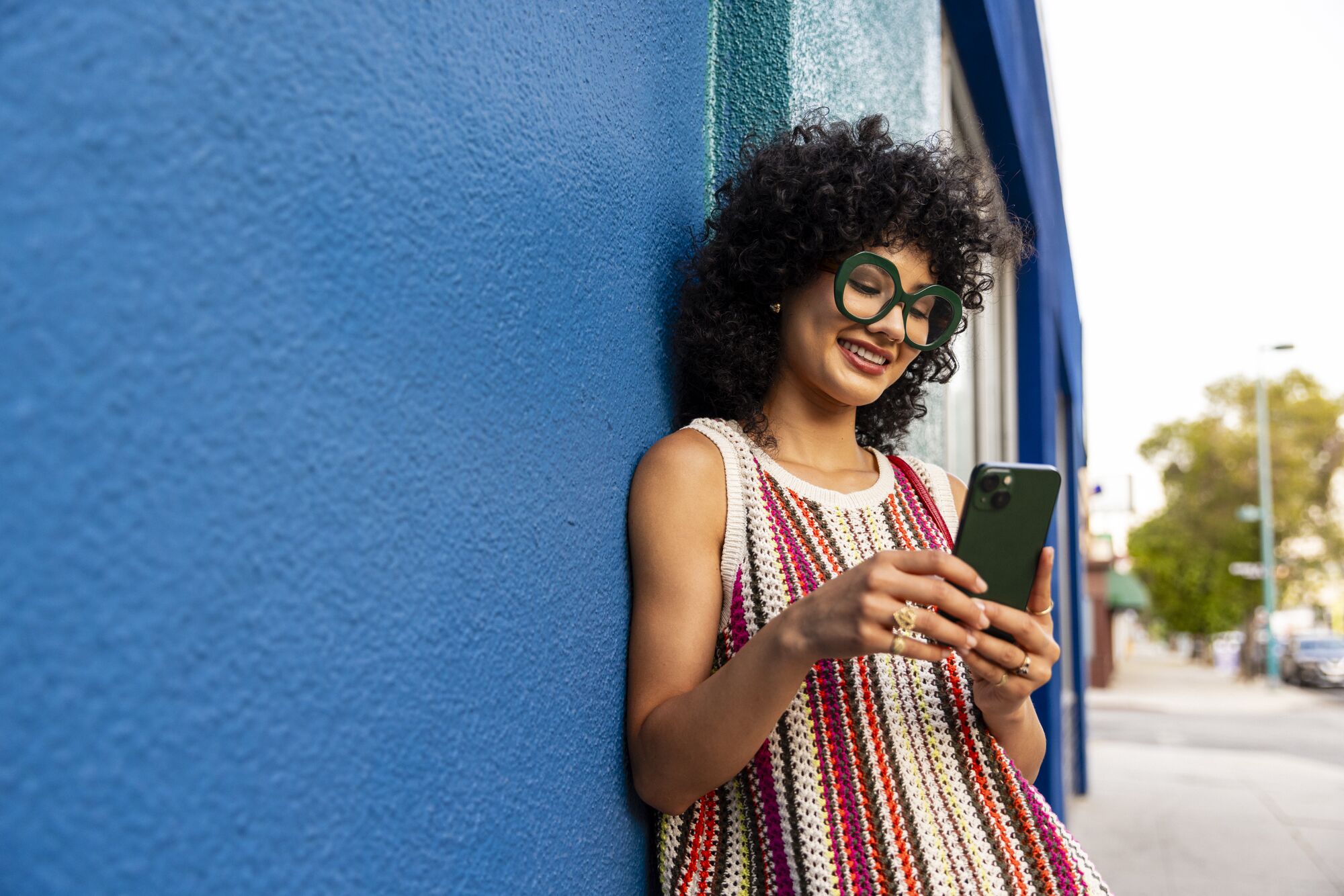 Stocksy_6236694_looking at phone